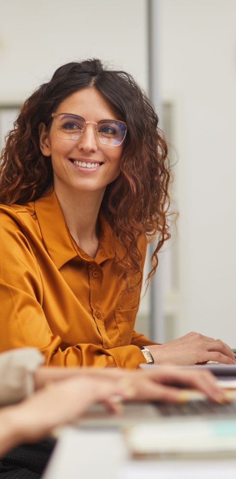 A person in a yellow top smiling